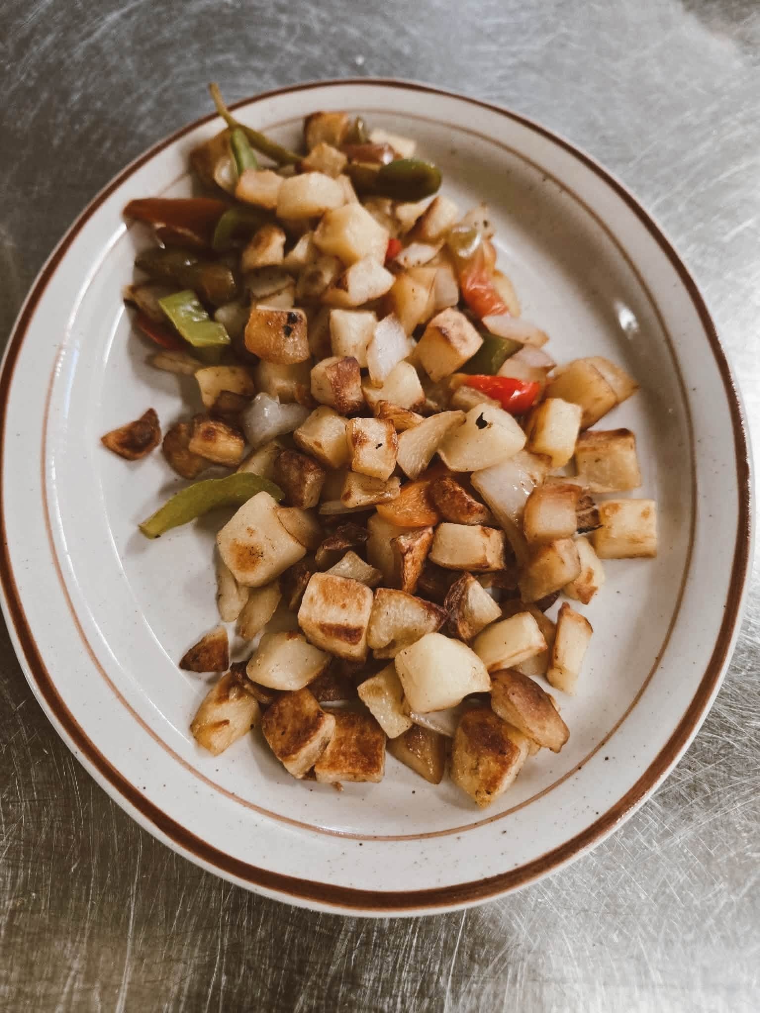 Home fries with peppers and onions at The Kove