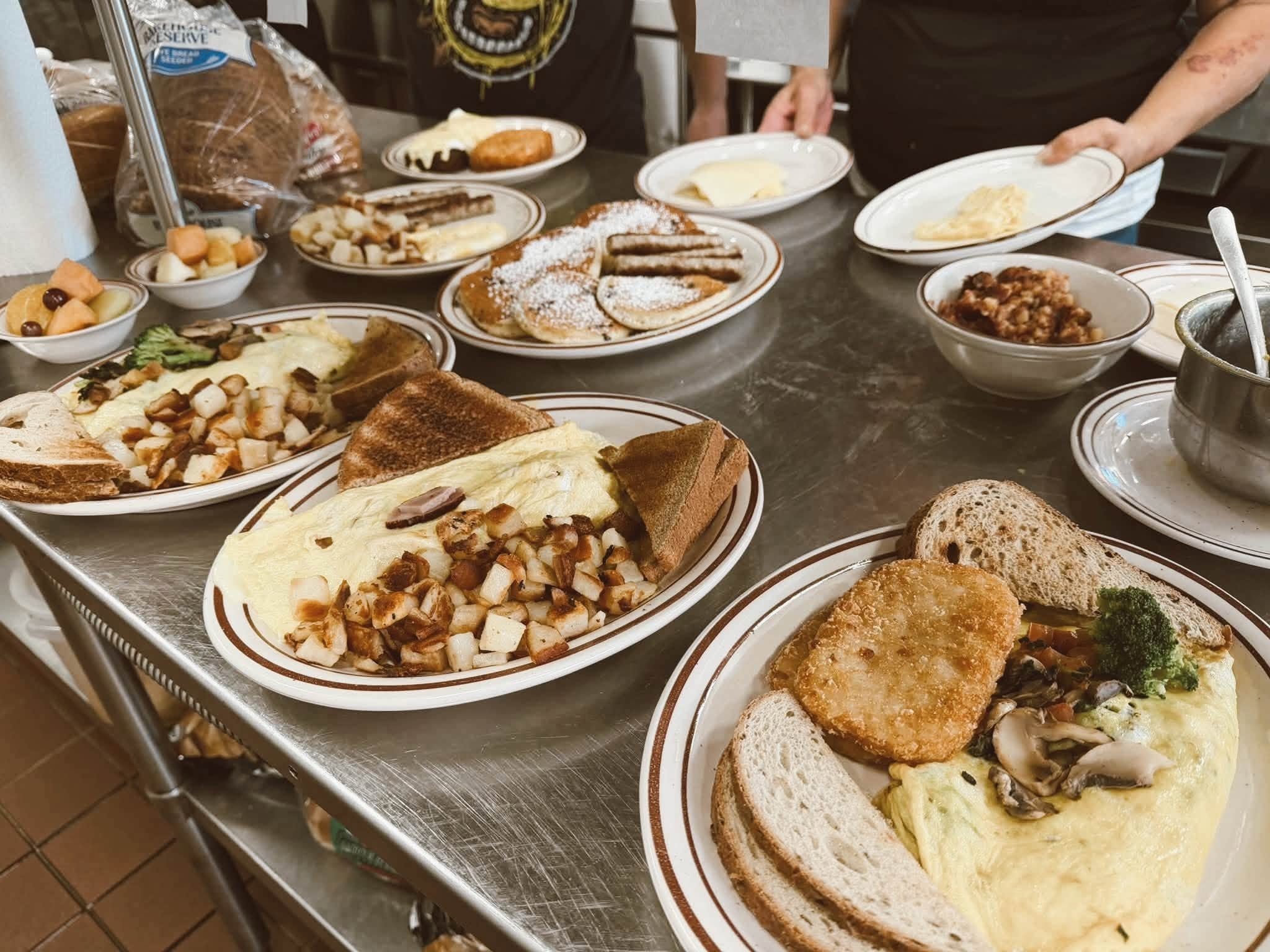 Full breakfast spread with omelets and sides at The Kove